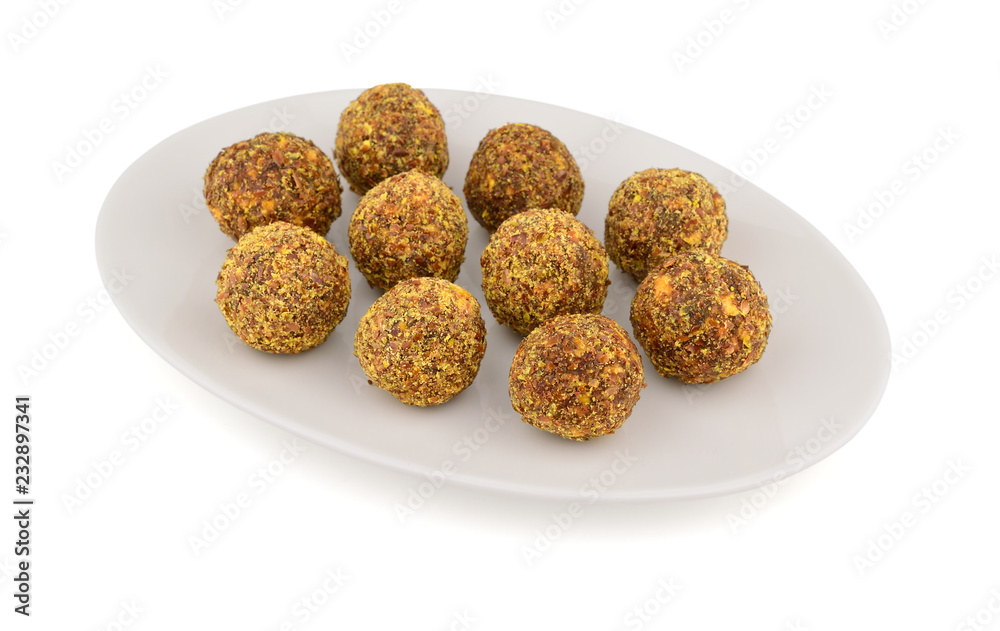 Homemade Candy with Fruits, Nuts and Honey on a Platter. Rich in Proteins, Fiber and Carbs Healthy Snack. Isolated on White. Homemade Candy with Fruits, Nuts and Honey on a Platter. Rich in Proteins, Fiber and Carbs Healthy Snack. Isolated on White.