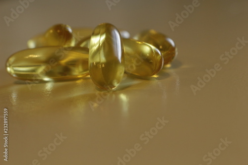 Close up yellow Cod Liver Oil capsule on white background, fish oil is a dietary supplement derived from liver of cod fish, have omega-3 fatty acids, EPA, DHA, vitamin A and D