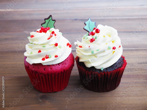 Red velvet and black forest cupcakes in christmas tree shape on wooden table background.
