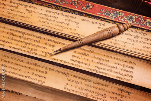 pen for writing text on Bai Lan background, Bai Lan or ancient palm leaf manuscripts content about buddhist scriptures, Pali language Khmer photo