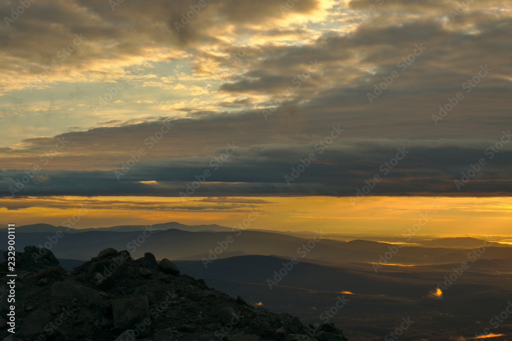 Mountains during sunrise and glowing fog in the valleys. Beautiful natural panoramic landscape