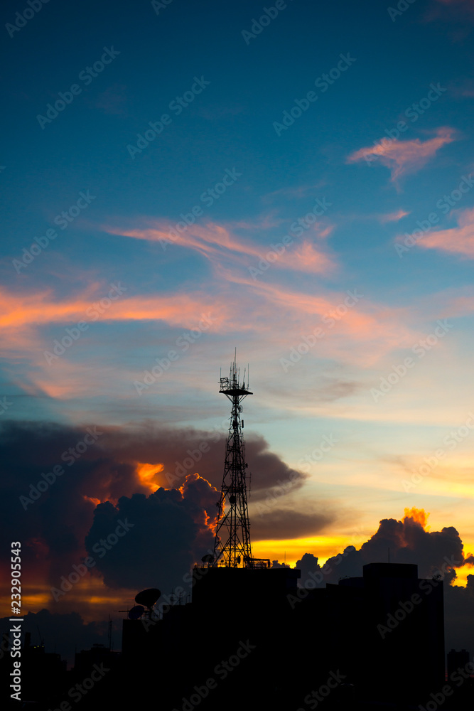 Silhouette of cellular tower with Civil twilight Sky and Clouds