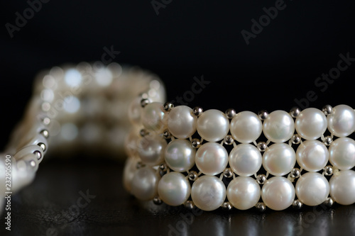 White pearl necklace on a dark background close up