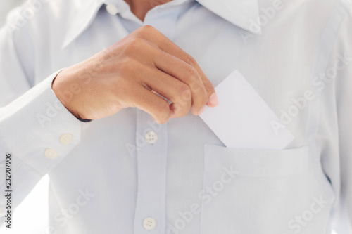 man holding card in pocket.