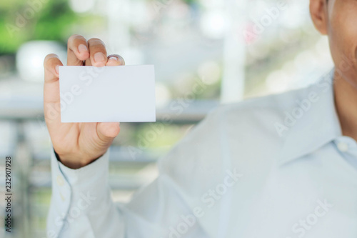 man holding white card.