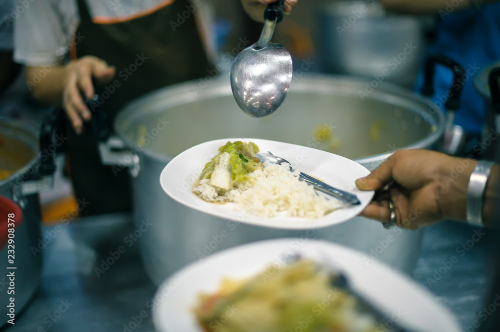 The hands of the poor receive food from the hands of the philanthropist : concept of giving The hands of the poor receive food from the hands of the philanthropist : concept of giving
