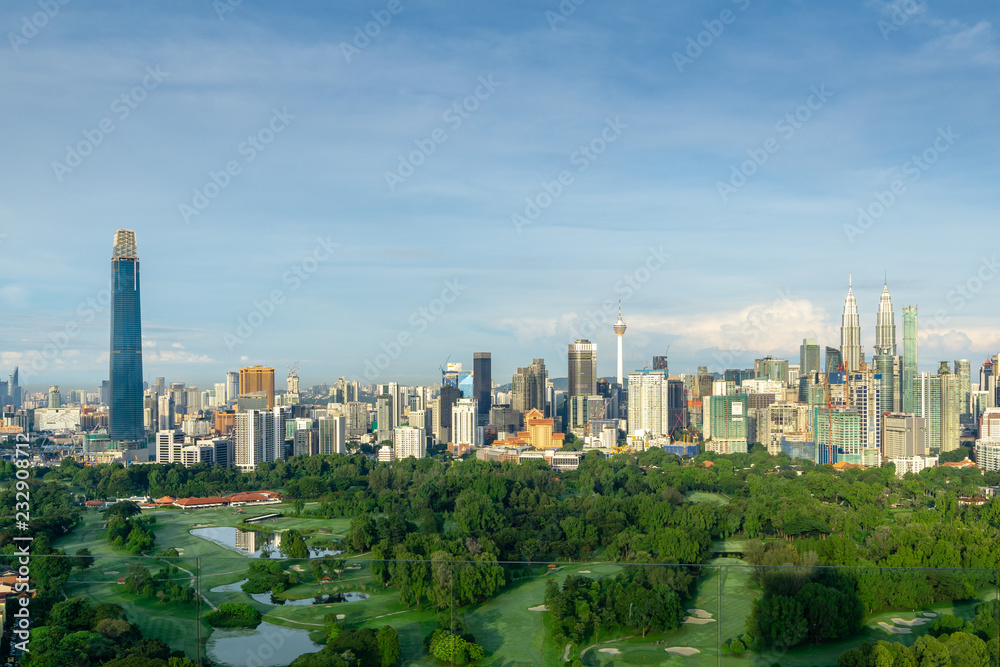 Fototapeta premium KUALA LUMPUR, MALAYSIA - 11th NOV 2018; Morning view over Kuala Lumpur, capital of Malaysia. Its modern skyline is dominated by the 451m tall KLCC, a pair of glass and steel clad skyscrapers.