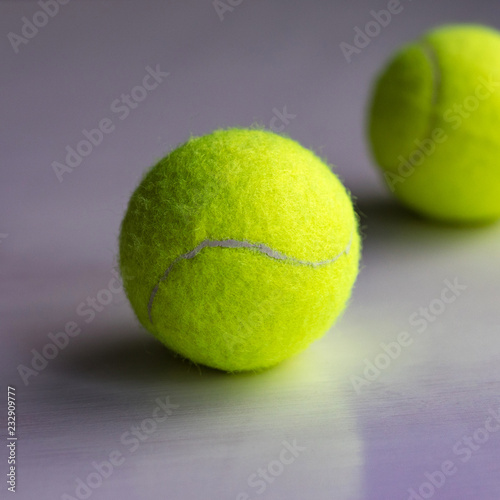 Yellow tennis ball with reflection below © Olya