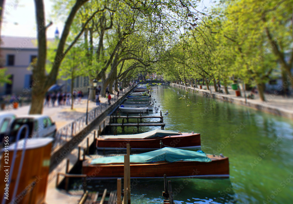 Annecy, France - April 21, 2011: View of river and boats from Pont des Amours (Bridge of Love) in Annecy France. Annecy is a commune in the Haute Savoie department of the Rhone-Alpes. Annecy, France - April 21, 2011: View of river and boats from Pont des Amours (Bridge of Love) in Annecy France. Annecy is a commune in the Haute Savoie department of the Rhone-Alpes.