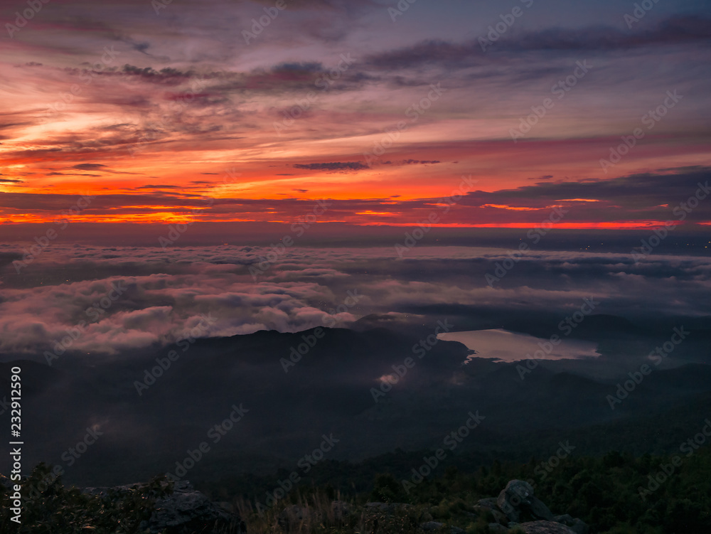 Beautiful Sunrise Sky with Sea of the mist of fog and heart shaped lake  in the morning on Khao Luang mountain in Ramkhamhaeng National Park,Sukhothai province Thailand