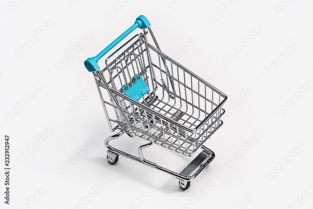 Small empty shopping trolley. Top view, copy space.