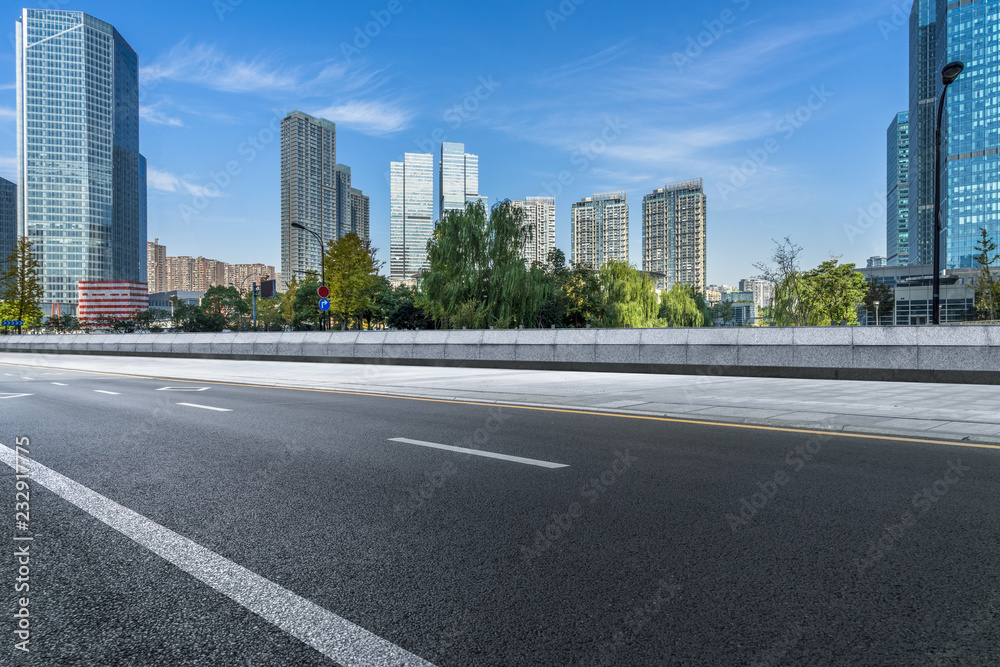 empty asphalt road with city skyline background in china. empty asphalt road with city skyline background in china.