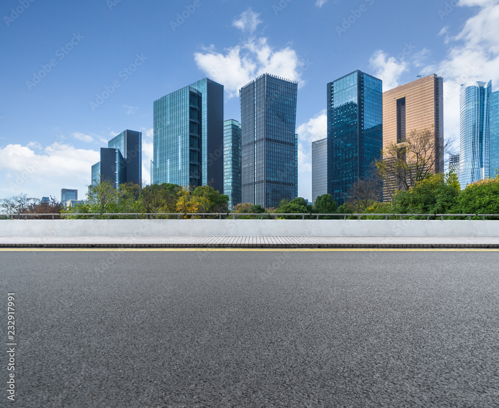 empty asphalt road with city skyline background in china. empty asphalt road with city skyline background in china.