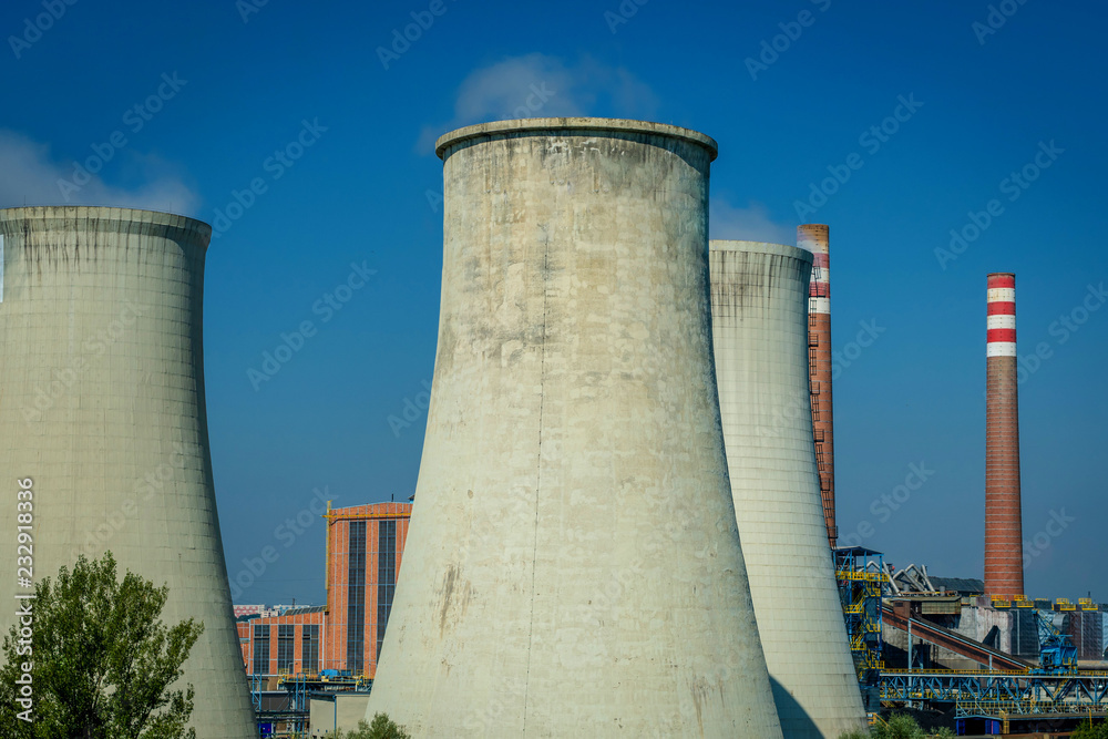 Modern power station cooling towers against a blue sky. Modern power station cooling towers against a blue sky.