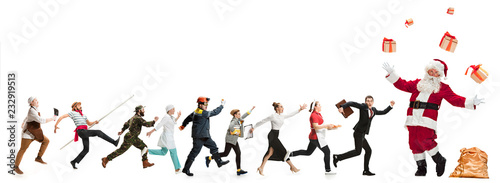 Collage of different professions. Group of men, women in uniform running at studio with Santa isolated on white. Full length of people with different occupations. Christmas and holiday concept