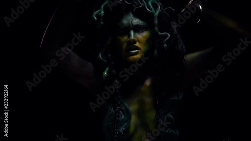 Screaming Medusa Gorgon on black background photo