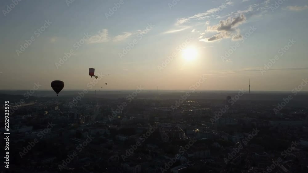 Aerial view of hot air balloons over Vilnius city, Lithuania. Hot air balloons floating over city at dawn. Aerial view of hot air balloons over Vilnius city, Lithuania. Hot air balloons floating over city at dawn.