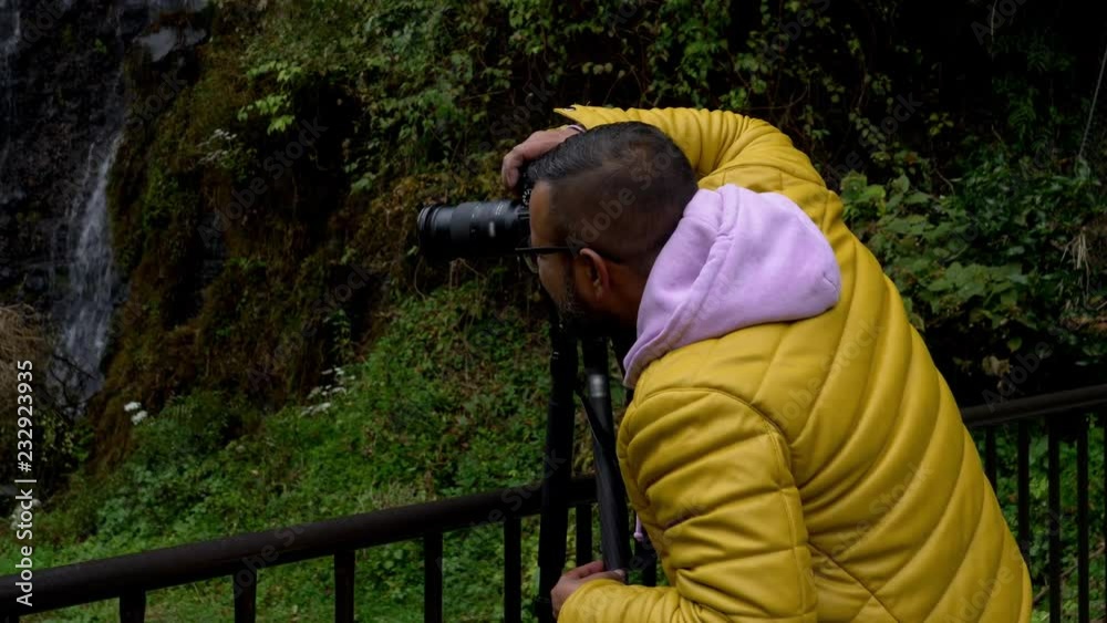 A Man Shooting Landscape Photographs with his Mirrorless DSLR at Shiraito Falls in Fujinomiya City, Shizuoka Pref., Japan A Man Shooting Landscape Photographs with his Mirrorless DSLR at Shiraito Falls in Fujinomiya City, Shizuoka Pref., Japan