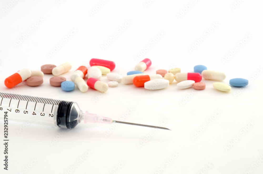 Syringes and tablets on white background Syringes and tablets on white background