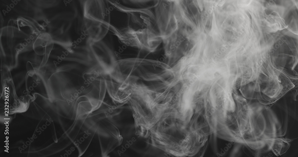 Obraz premium closeup vapor rises from bottom on black background