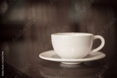 Blur coffee cup in dark tone.