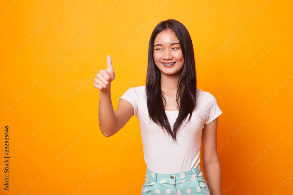 Asian woman thumbs up  and smile.