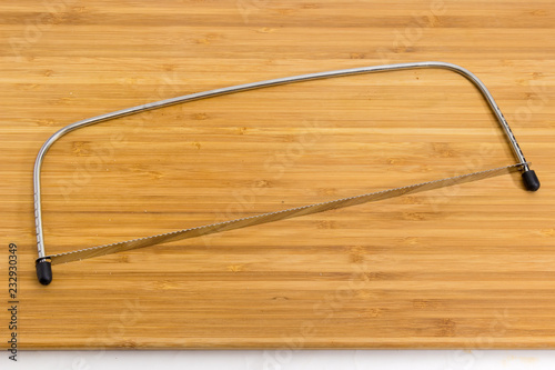 Adjustable cake leveler cutter slicer on wooden cutting board