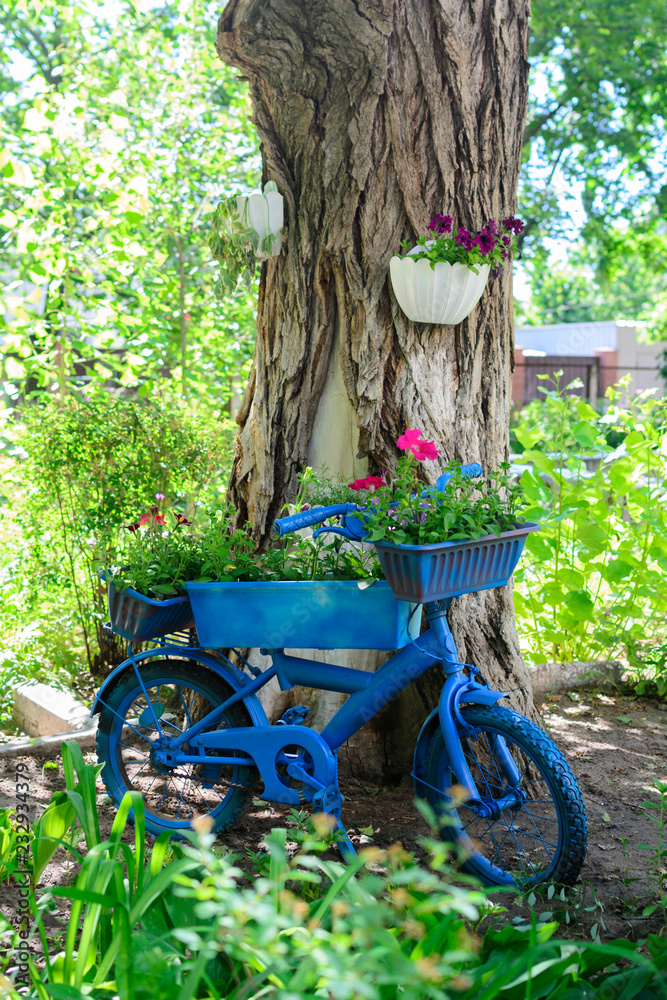 Garden landscape design decor bike in flowers