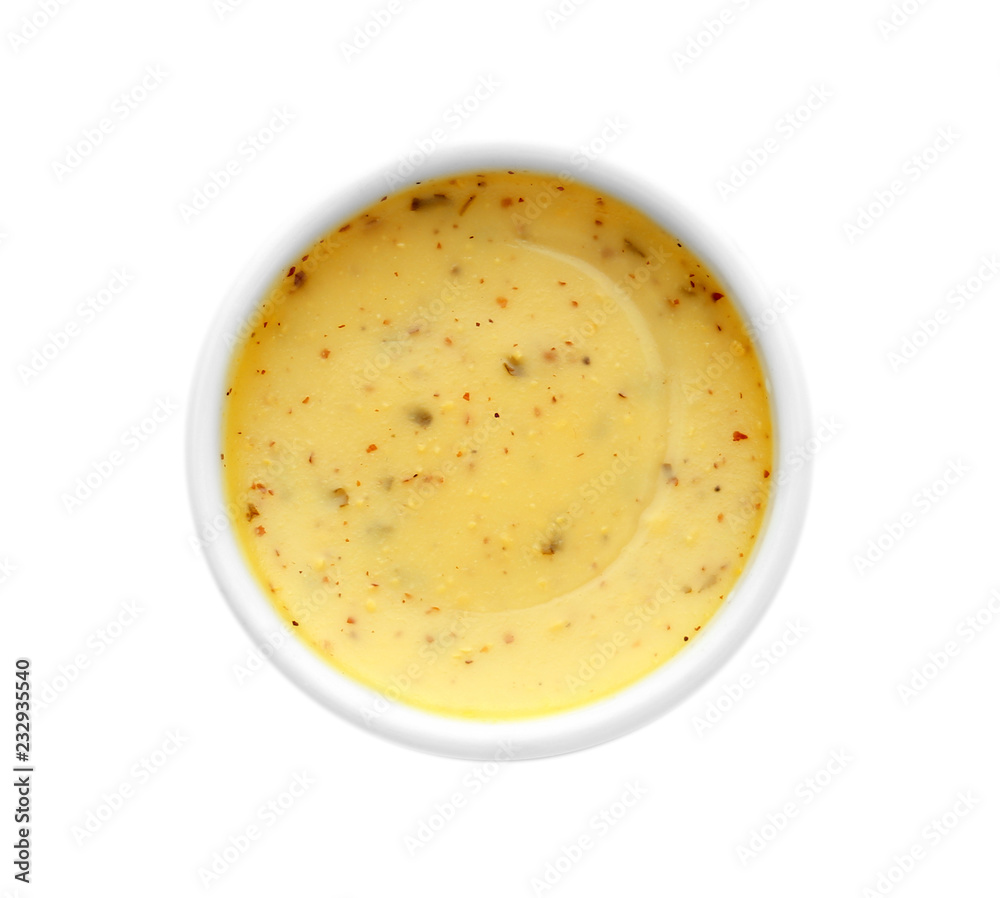 Tasty yellow sauce in bowl on white background Tasty yellow sauce in bowl on white background