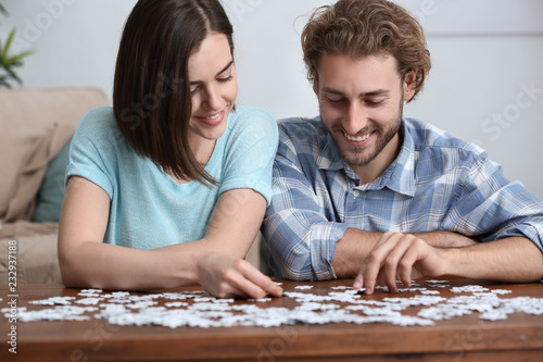 Young couple doing jigsaw p...