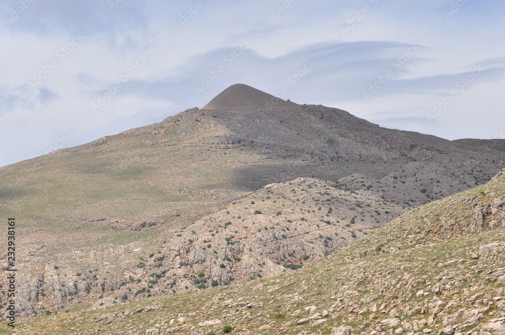 Nemrut Dagi. Mountains on the background of sky. Vertices covered with snow. Tourism and travel. Nemrut Dagi. Mountains on the background of sky. Vertices covered with snow. Tourism and travel.