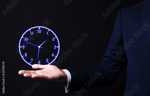 businessman holding a clock