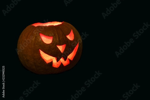halloween pumpkin with red eyes on black background