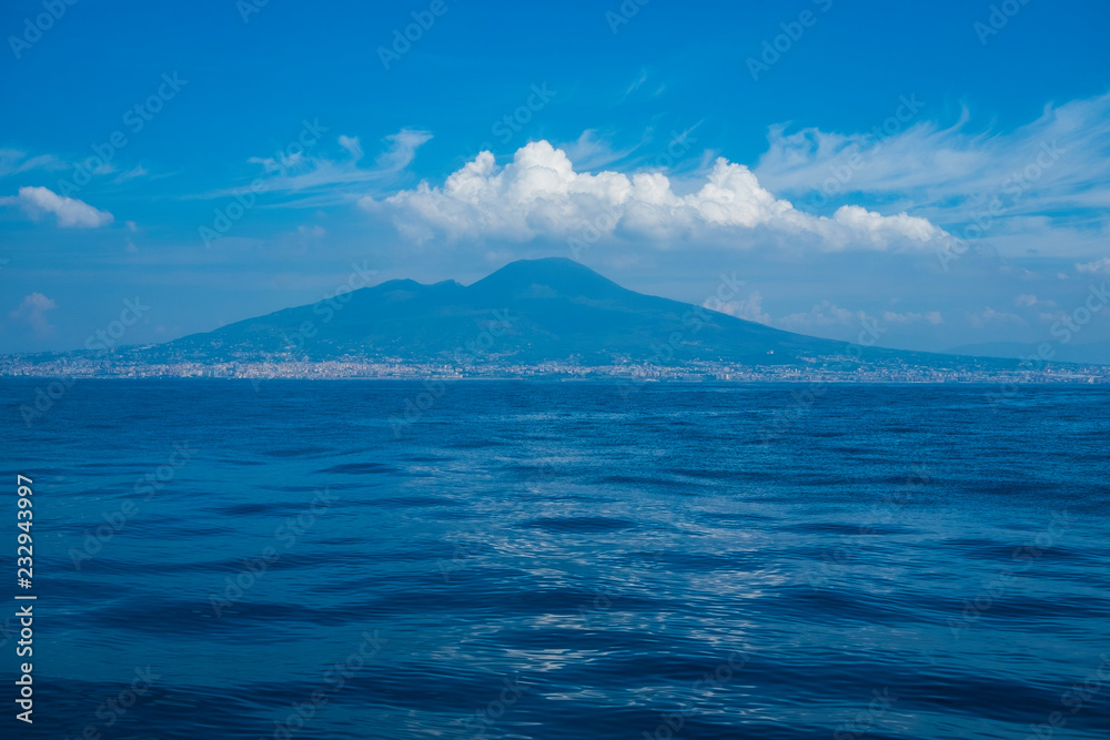 seaview from cruise boat of naples with vesuvio vulcan and campania cliff of italy in mediterranean water. wave and travel concept for tourist in summer vacation enjoying europe
