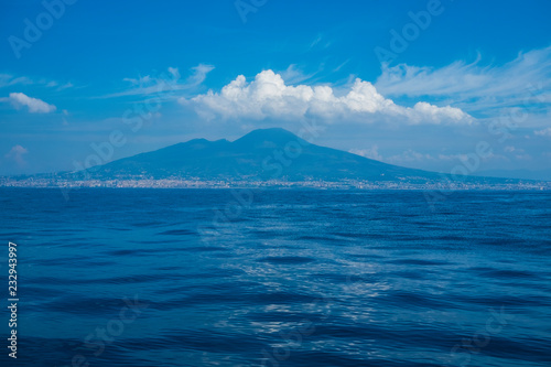 seaview from cruise boat of naples with vesuvio vulcan and campania cliff of italy in mediterranean water. wave and travel concept for tourist in summer vacation enjoying europe