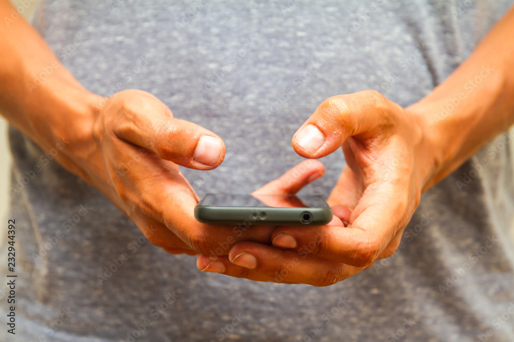 Male hands using smartphone. person holding a tactile mobile smartphone Male hands using smartphone. person holding a tactile mobile smartphone