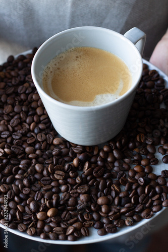 black coffee on a tray in male hands.