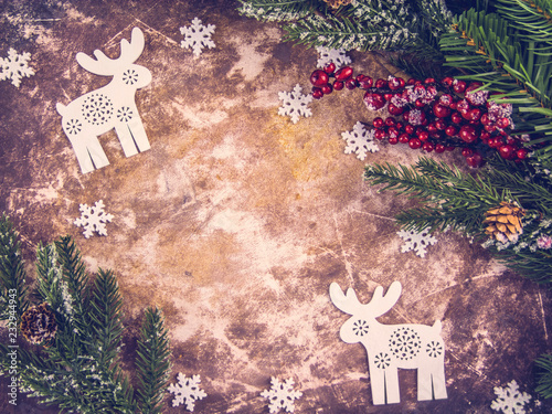 Christmas decorations, deer, fir branches, snowflakes on a brown background