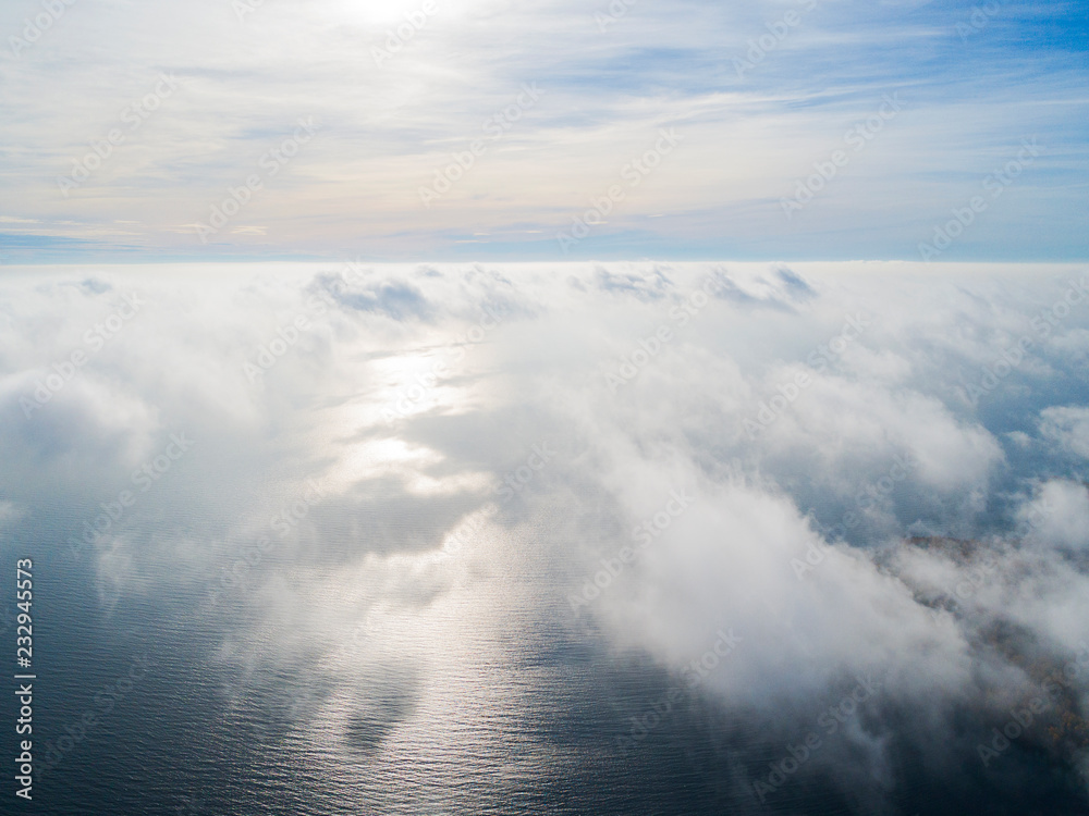 Aerial view of a Sunset sky background. Aerial Dramatic gold sunset sky with evening sky clouds over the sea. Stunning sky clouds in the sunset. Sky landscape. Aerial photography.