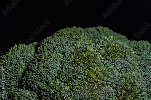 Broccoli cabbage on a black background close-up © Igor