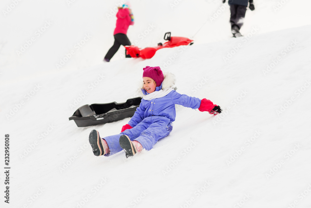 childhood, sledging and season concept - group of happy little kids with sleds on snow hill in winter