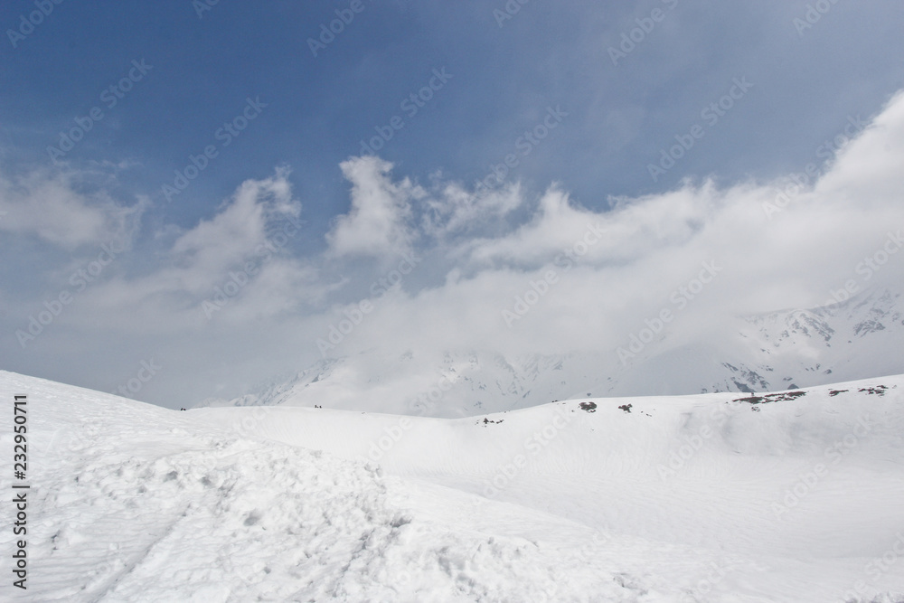 Snow hill scene of tateyama mount in japan with blue sky
