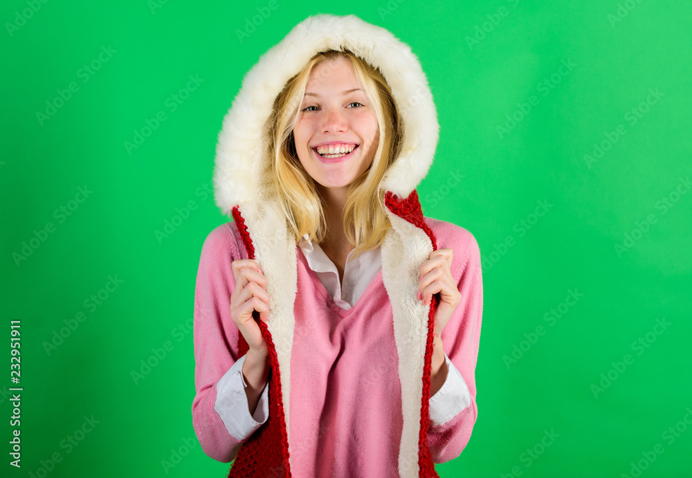 Girl cheerful blonde warming up wear fur hood on green background. Woman emotional face posing in warm furry hood. Winter time for cozy warm accessories. Lets stay warm in fur clothing Girl cheerful blonde warming up wear fur hood on green background. Woman emotional face posing in warm furry hood. Winter time for cozy warm accessories. Lets stay warm in fur clothing