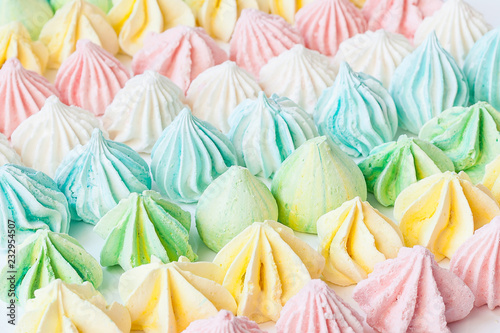 Colored meringues on white backround. Sevective focus