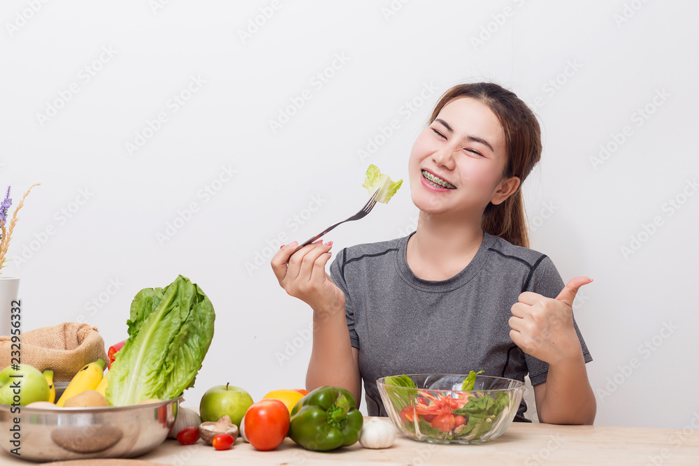 Enjoyed Asian woman eating vegetable salad. Enjoyed Asian woman eating vegetable salad.