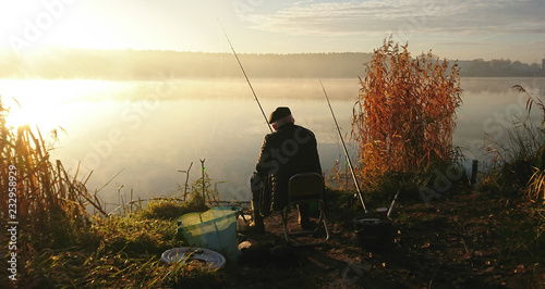 Amatorski wędkarz łowi na jesieni w jeziorze photo
