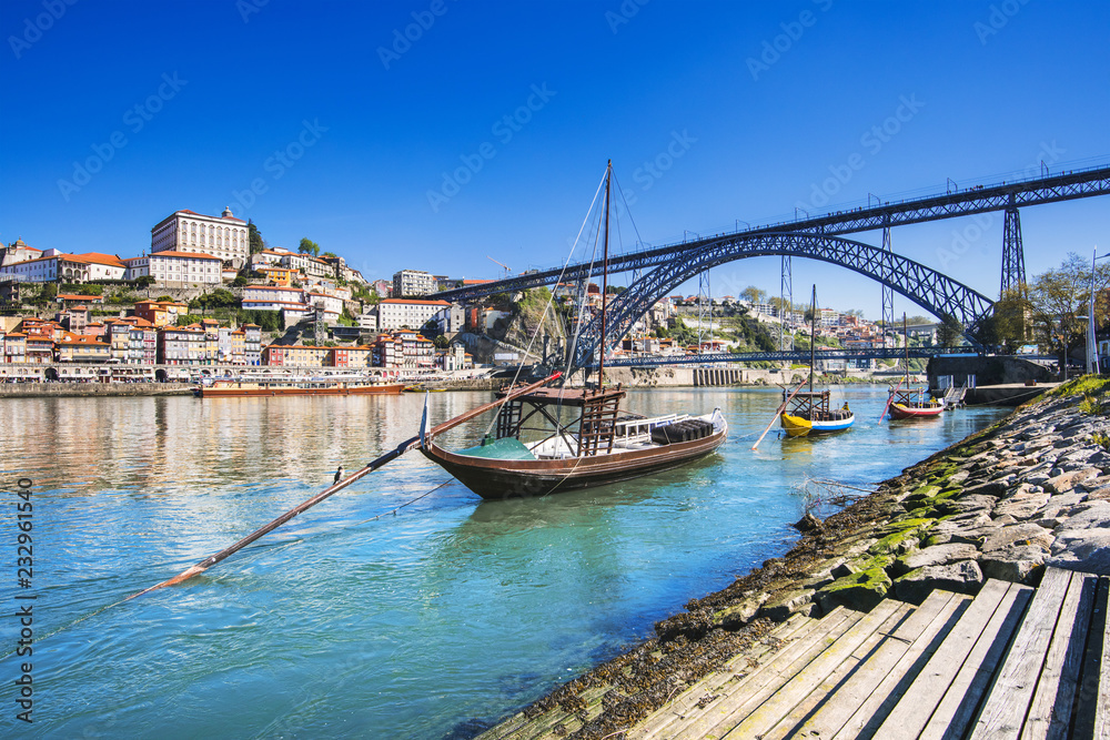 View of Porto, Portugal. Boats with port wine barrels on Douro river.