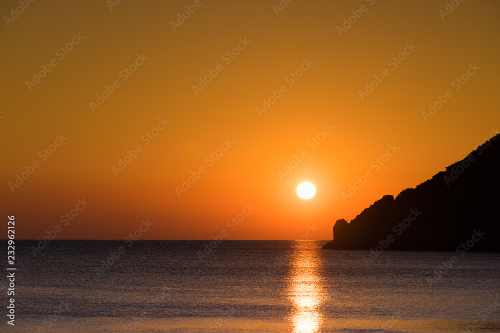 Sunset or sunrise over sea surface Sunset or sunrise over sea surface