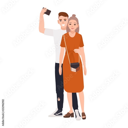 Young smiling man and woman standing together and taking selfie. Happy romant...
