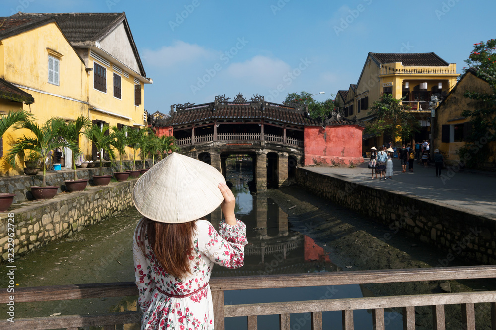 Tourist is traveling at Japanese bridge in Hoi An, Vietnam.